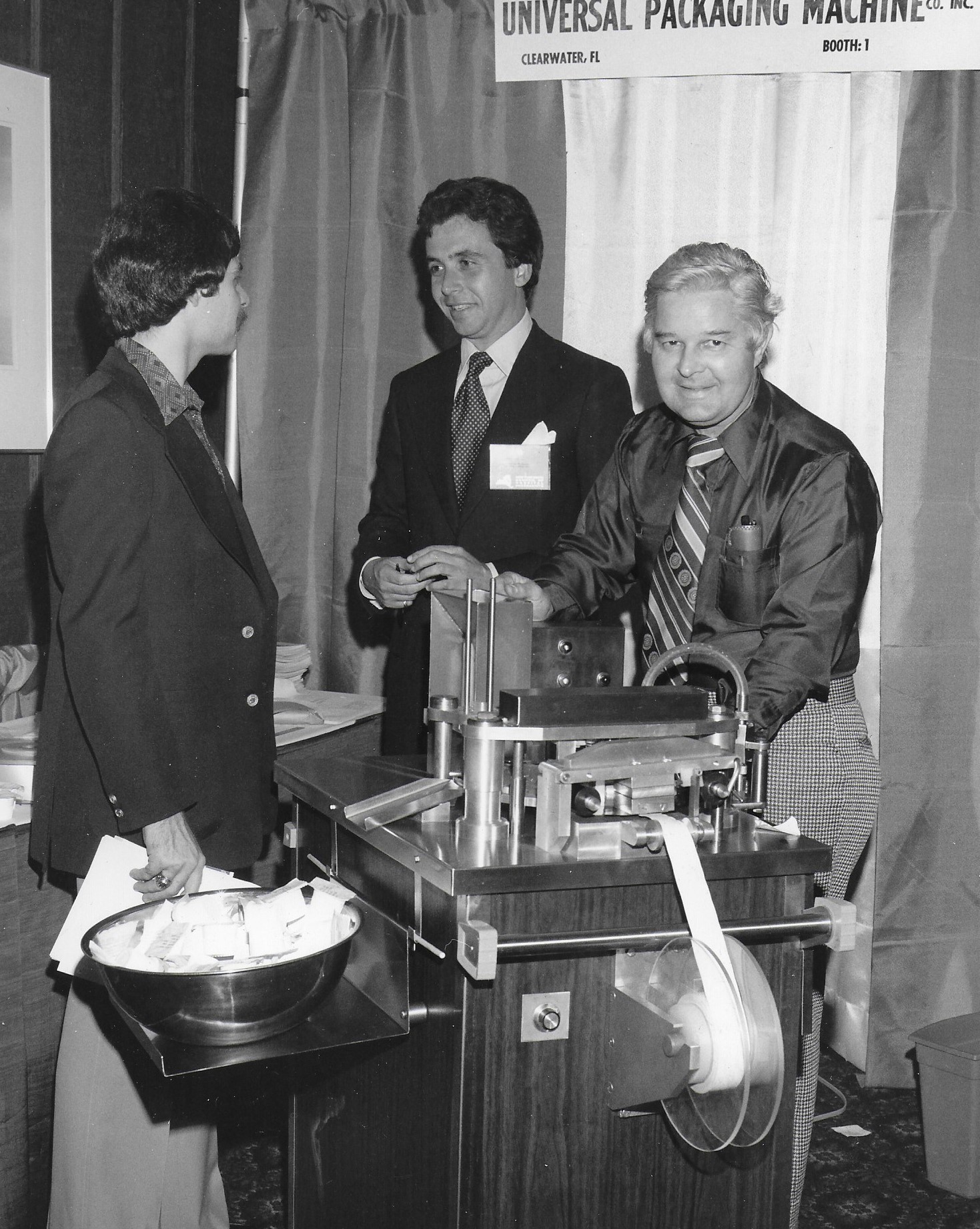 A boothperson demonstrating for another conferencegoer