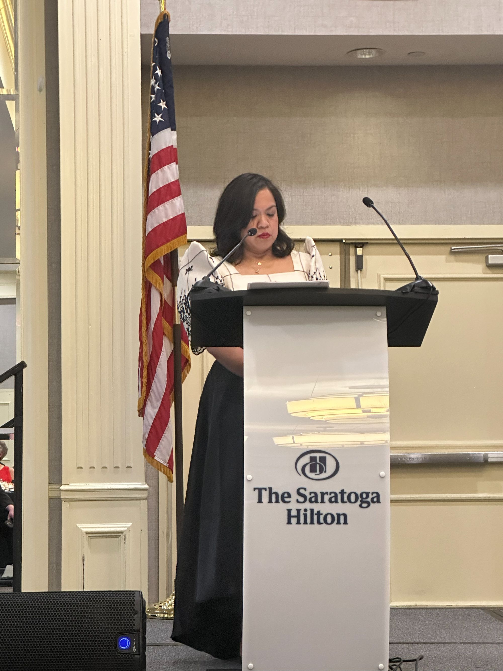Leila Tibi stands at the podium